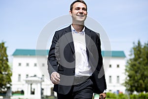 Portrait of a young business man in a dark suit and white shirt