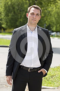 Portrait of a young business man in a dark suit and white shirt