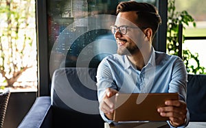 Portrait of young business man working on digital tablet