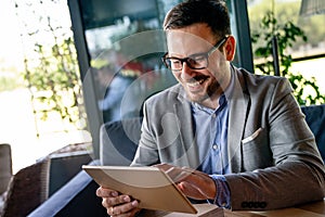 Portrait of young business man working on digital tablet