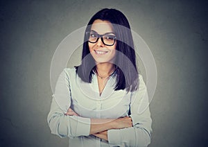 Portrait of young business woman on gray wall background