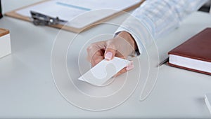 Portrait of young business woman holding blank white business card