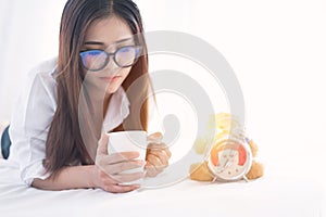 Portrait of a young business woman ,laptop,cup of coffee. Business concept a laptop drinking coffee with her computer on the bed