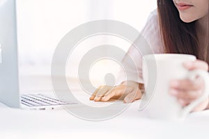 Portrait of a young business woman ,laptop,cup of coffee. Business concept a laptop drinking coffee with her computer on the bed