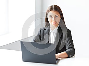 Portrait of young business woman with laptop in the offic