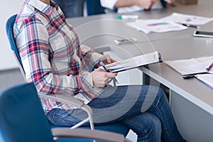 Portrait of young business woman at office with team on meeting