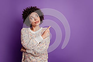 Portrait of young business woman pointing fingers empty space look up isolated on purple background