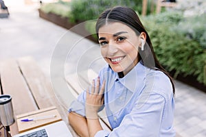 Portrait of young business woman sitting outside of his office building