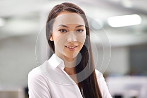 Portrait, young and business woman with smile in office, closeup and professional person with ambition in career. Pride