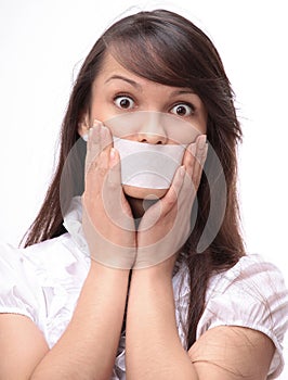 Portrait of young business woman with taped mouth