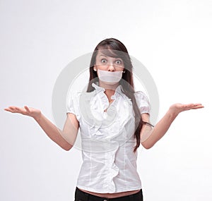 Portrait of young business woman with taped mouth