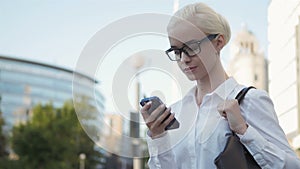 Portrait of Young Business Woman Typing Text Message On Phone Outdoors