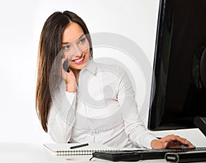 Portrait of a young business woman using computer at office