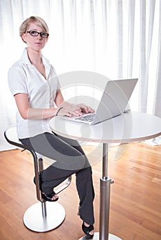 Portrait young business woman working with computer