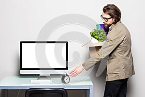 Portrait of a young businessman carrying box at his workplace. Fired from work