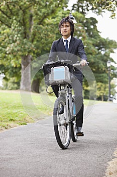 Portrait of young businessman commuting by his bicycle