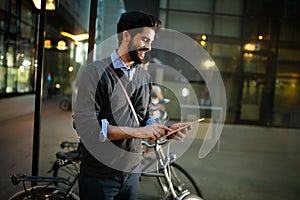 Portrait of young businessman holding tablet outdoor