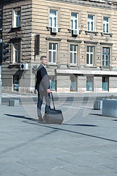 Portrait Of young Businessman  Outside Office. Meeting Concept. Man Walking and drinking coffe, going to the office