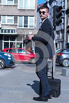 Portrait Of young Businessman  Outside Office. Meeting Concept. Man Walking and drinking coffe, going to the office