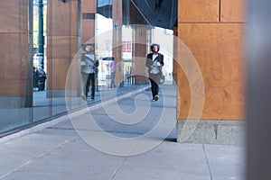 Portrait Of young Businessman  Outside Office. Meeting Concept. Man Walking and drinking coffe, going to the office