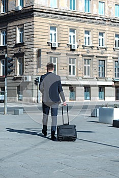 Portrait Of young Businessman  Outside Office. Meeting Concept. Man Walking and drinking coffe, going to the office