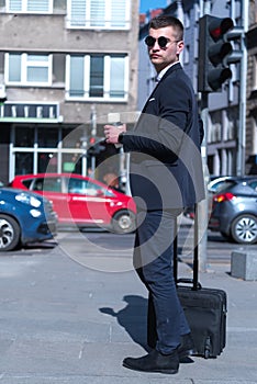 Portrait Of young Businessman  Outside Office. Meeting Concept. Man Walking and drinking coffe, going to the office