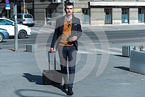 Portrait Of young Businessman  Outside Office. Meeting Concept. Man Walking and drinking coffe, going to the office