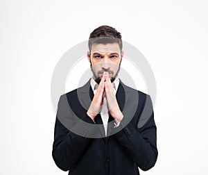 Portrait of a young businessman praying