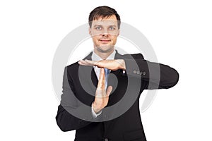 Portrait of young businessman showing time out sign with hands photo