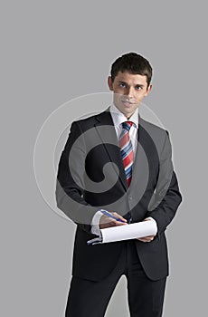 Portrait of a young businessman signing a document