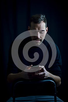 Portrait of a young businessman who is reading a message on his smartphone