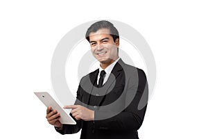 Portrait young businessman working on new tablet, mobile phone in white studio. Portrait of a confident business man in black suit