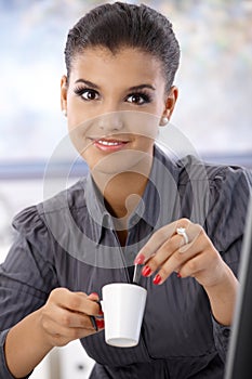 Portrait of young businesswoman with coffee