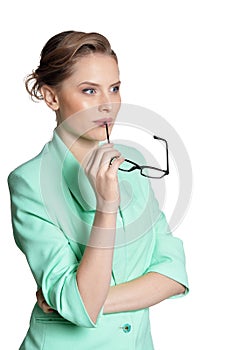 Portrait of young businesswoman with glasses on white background