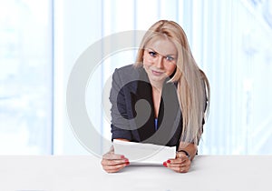 Portrait of young businesswoman holding a contract