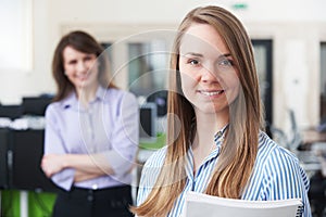 Portrait Of Young Businesswoman With Mentor In Office