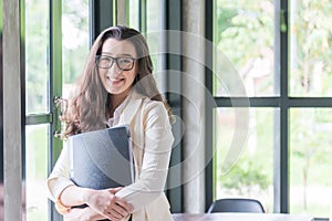 Portrait of young businesswoman smileing and holding document, . Success in business, job and education concept