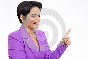 Portrait of young businesswoman smiling, pointing up