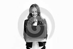 Portrait of young businesswoman using laptop computer isolated on gray background. Business women in suit excited