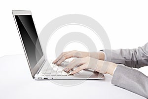 Portrait of young businesswoman using laptop,side view,close-up