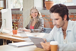 Portrait of young businesswoman working on computer photo