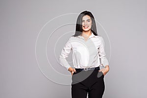 Portrait of young busineswoman standing over white background