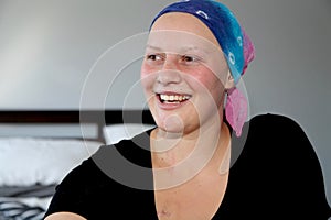 Portrait of a young cancer patient in a headscarf laughing