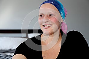 Portrait of a young cancer patient in a headscarf smiling