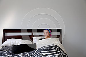 Portrait of a young cancer patient lying in bed sleeping