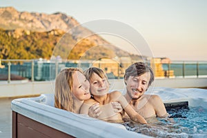Portrait of young carefree happy smiling happy family relaxing at hot tub during enjoying happy traveling moment