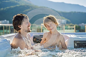 Portrait of young carefree happy smiling happy family relaxing at hot tub during enjoying happy traveling moment