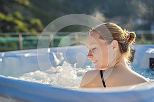 Portrait of young carefree happy smiling woman relaxing at hot tub during enjoying happy traveling moment vacation life