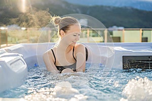 Portrait of young carefree happy smiling woman relaxing at hot tub during enjoying happy traveling moment vacation life