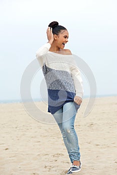 Portrait of a young carefree woman walking on the beach